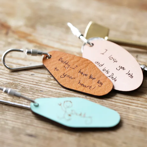 Personalised Handwriting Leather Tag Keyrings Three Personalised Handwriting Leather Tag Keyrings on Wooden Table