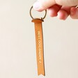 Model Holding Personalised Slim Banner Leather Keyring With Gold Finish