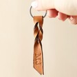 Model Holding Personalised Twisted Knot Leather Keyring in Brown