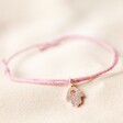 Hamsa Hand Charm Cord Friendship Bracelet in Pink on fabric background