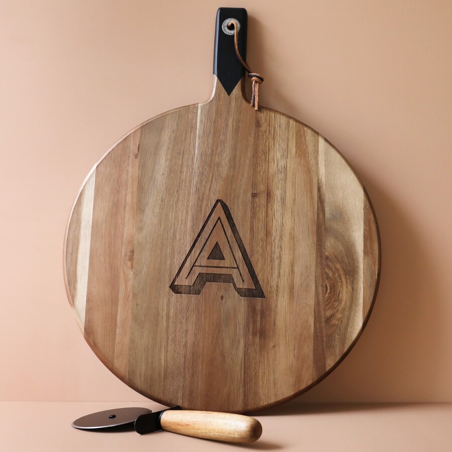 A Round Wooden Board with a Black Handle and an 'A' Engraving in the Centre