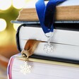 Snowflake Charm and Hamsa Hand Charm and Ribbon Bookmark in Books