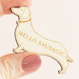Close up of model holding Wooden Hello Sausage Dog Token