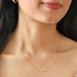 Model Wearing delicate Linked Filigree Leaf Necklace in Gold