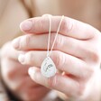 Model Holding Silver Personalised Birth Flower Antique Effect Pendant Necklace