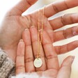 Model Holding Personalised Name Sterling Silver Disc Necklace in Gold