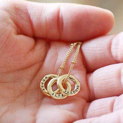 Model Holding Personalised Organic Hoops Necklace with Three Charms