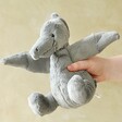 model holding Jellycat Fossilly Pterodactyl Soft Toy