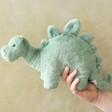 Model Holding Jellycat Fossilly Stegosaurus Soft Toy