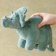 Model holding Jellycat Fossilly Triceratops Soft Toy