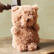 Jellycat Little Bear Soft Toy sat on brown wooden chair