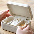 model opening personalised mother's day natural linen jewellery case to reveal top layer with rings and earrings
