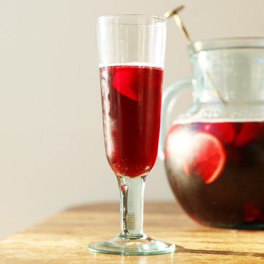 Recycled Stemmed Prosecco Glass on brown table with Liquid Inside