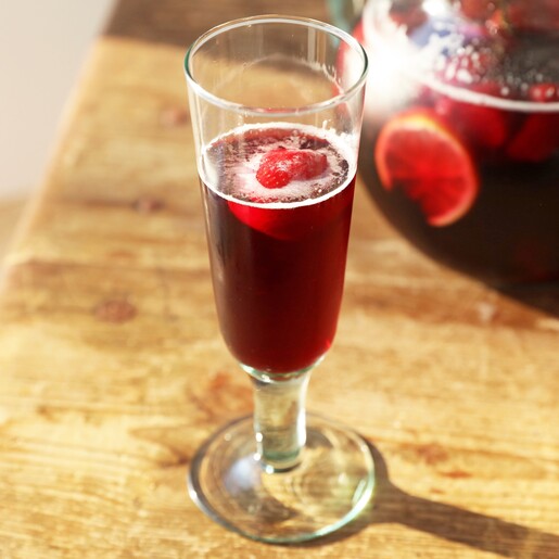 Recycled Stemmed Prosecco Glass on brown table with Drink inside