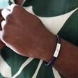 Model Wearing Personalised Men's Woven Leather Bracelet in Black and Blue