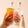 Model Holding Personalised Pair of 20cl Heart Couples' Spirits