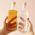 Model Holding Personalised Pair of 20cl Heart Outline Couples' Spirits