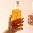 Model Holding One Bottle from Personalised Pair of 20cl Heart Outline Couples' Spirits