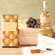 Contents of You’re the Bee’s Knees Gift Hamper on wooden table