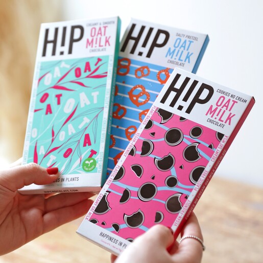 Model Holding a Selection of H!P Chocolate: Oat M!lk Chocolate Bars