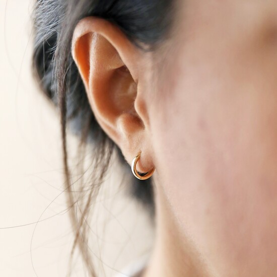 Small hoop sterling huggie earrings with gold plate. 