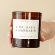 Model Holding Lime, Basil & Mandarin Scented Soy Candle