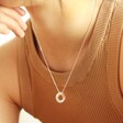 model wearing personalised sterling silver russian ring valentine's necklace with hand on chin