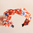 top of Twist Fabric Headband in Orange and White