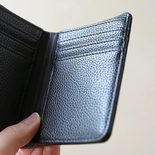 Inside of Vegan Leather Black Wallet Held by Model