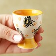 Model holding Sass & Belle Busy Bee Egg Cup