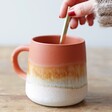 Model Stirring Liquid in Sass & Belle Mojave Glaze Brown Mug