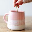 Model Stirring Tea in Sass & Belle Mojave Glaze Pink Mug