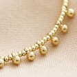 Close-up of Beaded Ball Charm Anklet in Gold