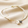 White Beaded Shell Charm Anklet on Beige Fabric