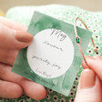 Model Holding May Organic Style Birthstone Bangle in Packaging