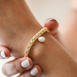 Model Wearing Plaited Rope Chain Bracelet with Pearl in Gold