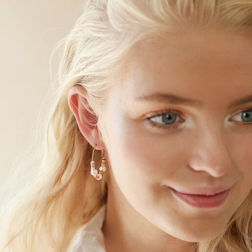 Colourful Bead and Pearl Hoop Earrings in Gold on Model