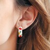 Brunette Model Wearing Colourful Fruits Enamel Hoop Earrings in Gold