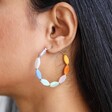 Close Up of Colourful Glass Beaded Hoop Earrings in Gold on Model