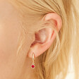 July Ruby Gold Birthstone Huggie Hoop Earrings on Model