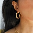 Model Wearing Gold Polished Hoop Earrings