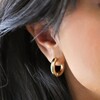 Close Up of Model Wearing Medium Chunky Hoop Earrings in Gold