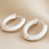 Medium Chunky Hoop Earrings in Silver on Beige Fabric