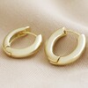 Medium Chunky Hoop Earrings in Gold on Beige Fabric