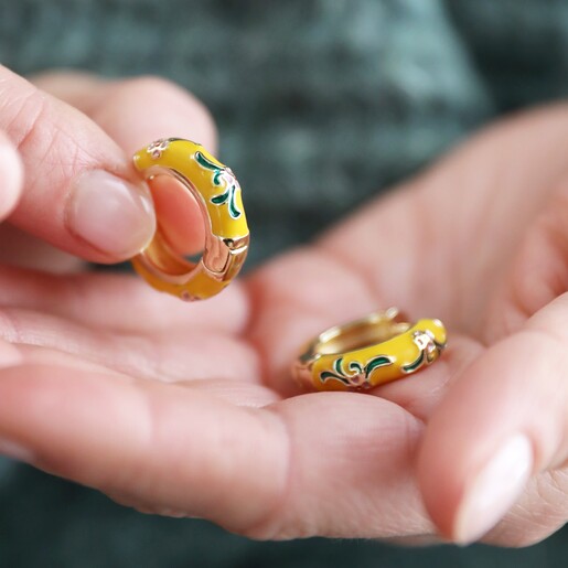 Model Holding Mustard Floral Enamel Hoop Earrings in Gold