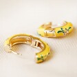 Open and Closed Mustard Floral Enamel Hoop Earrings in Gold on Fabric