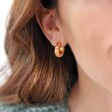Brunette Model Wearing Orange Geometric Enamel Hoop Earrings in Gold