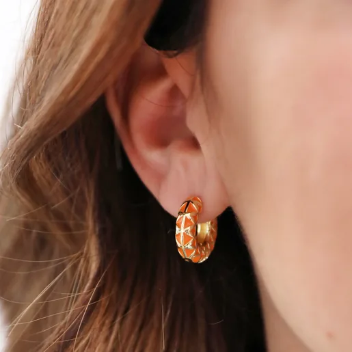 Close Up of Model Wearing Orange Geometric Enamel Hoop Earrings in Gold