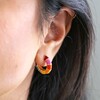 close up of model wearing Rainbow Geometric Enamel Hoop Earrings in Gold