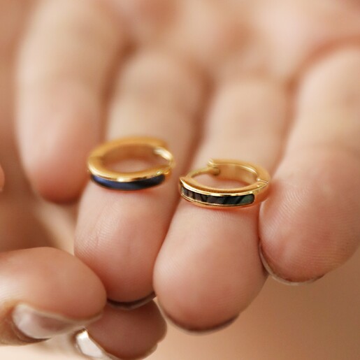 Model Holding Shell Black Resin Infill Huggie Hoop Earrings in Gold